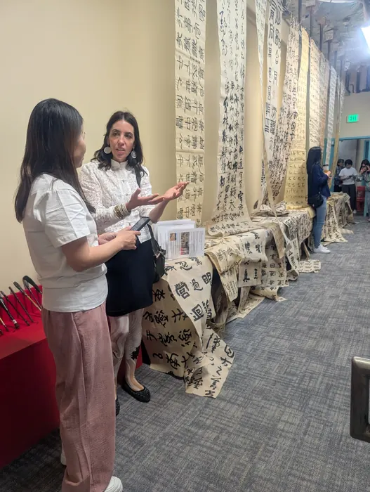 Visitors inside the hanging calligraphy installation