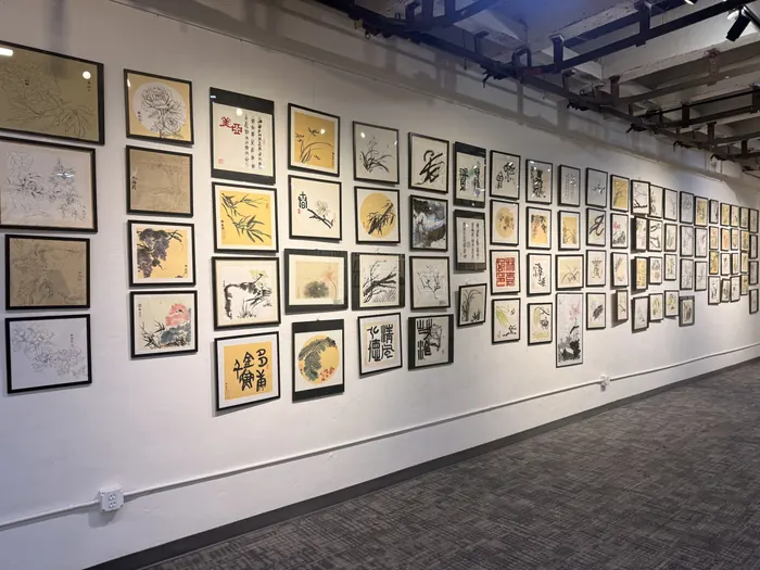 Ink paintings framed along the wall