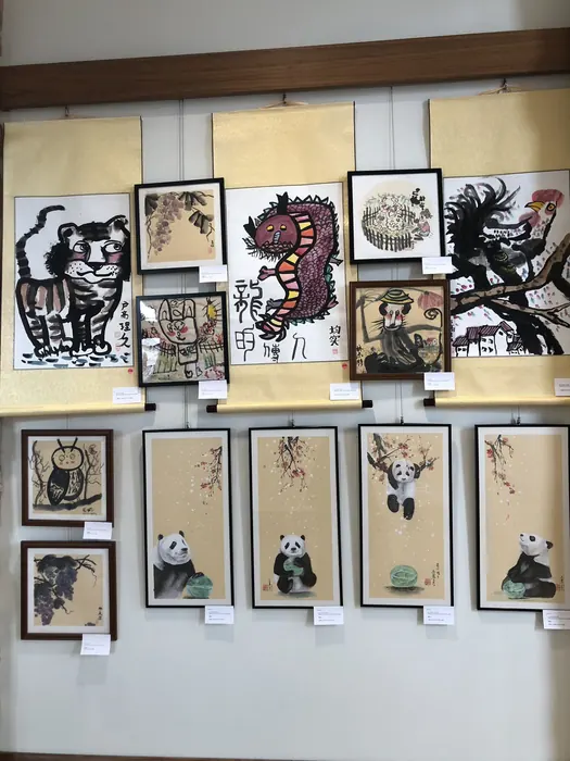 Framed ink paintings on the exhibition wall