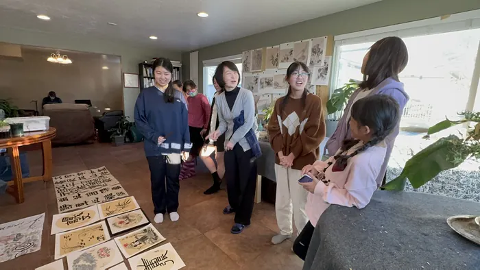 Visitors looking over the work on display