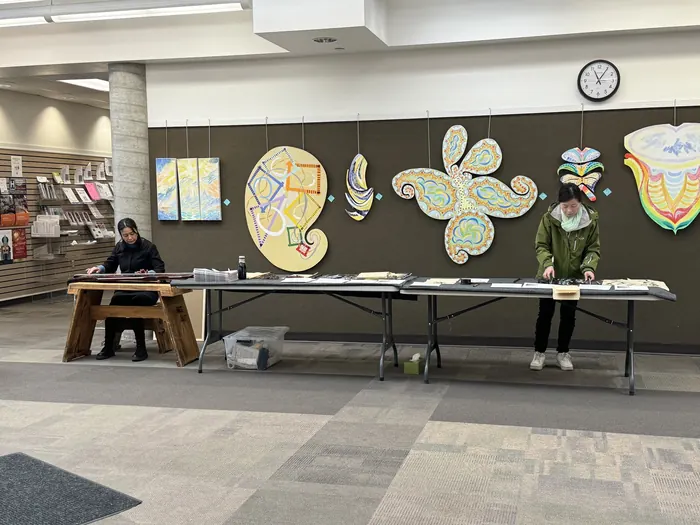 Round paintings hung for the library exhibition