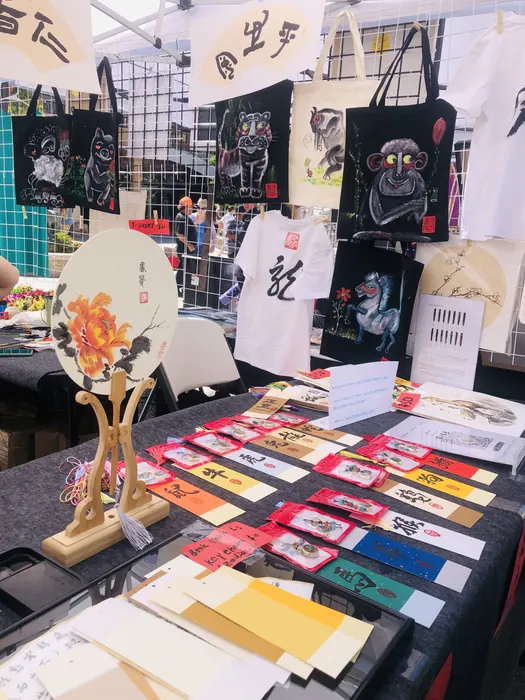 A painted fan standing above the display table