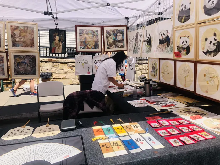 Ink paintings and painted fans on display