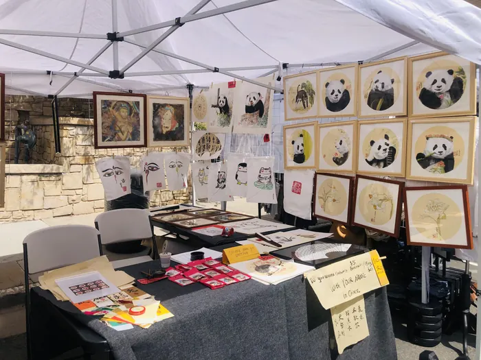 Cards, fans, and paintings on the display table